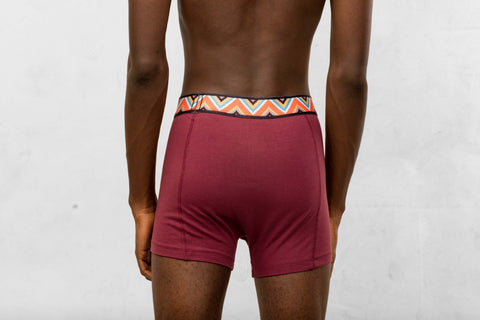 a man in a red boxers with a colorful waistband 