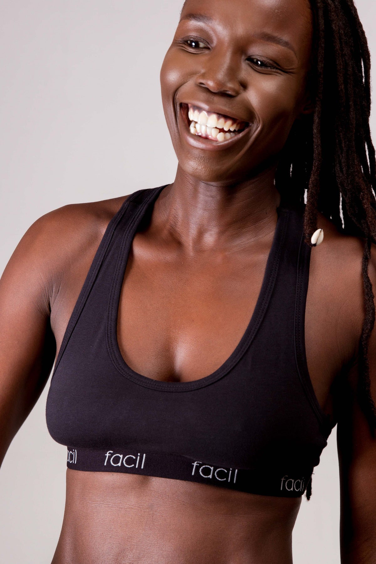 a woman in a black cotton bralette smiling
