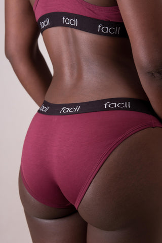 a close up of a woman in a burgundy underwear