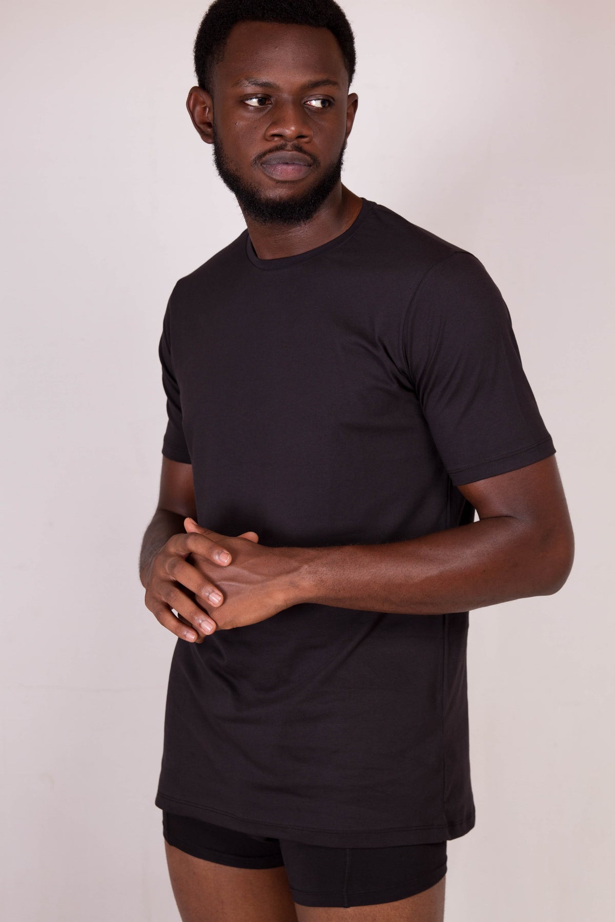 a man in a black shirt is posing for a picture
