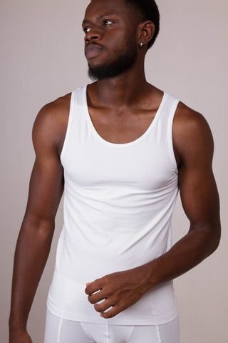 a man with a beard wearing a white tank top
